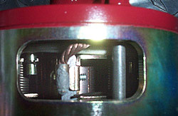 closeup of motor, showing one brushholder and commutator
